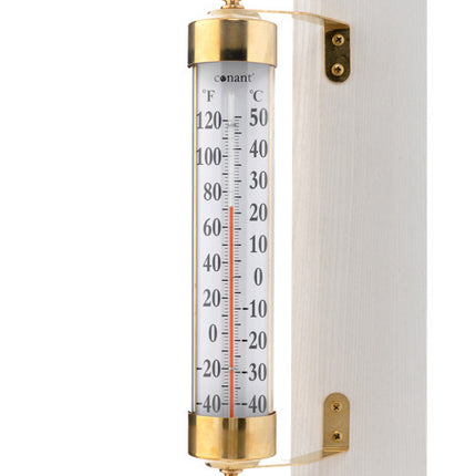 a close up of  A Brass and reliable thermostat telling you the degrees and celsius of that day.