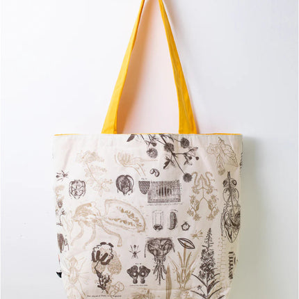 side two of the honey bee tote; a white tote bag with yellow straps covered in vintage illustrations and academic diagrams of the honey bee