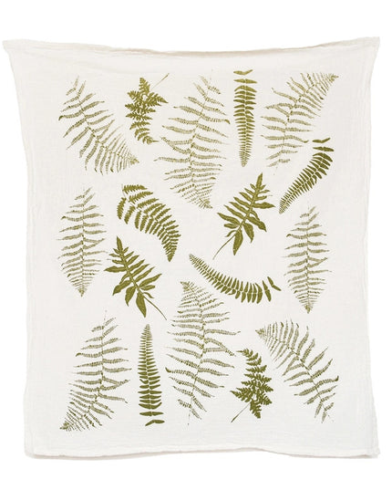an off white tea towel with illustrations of green fern fronds