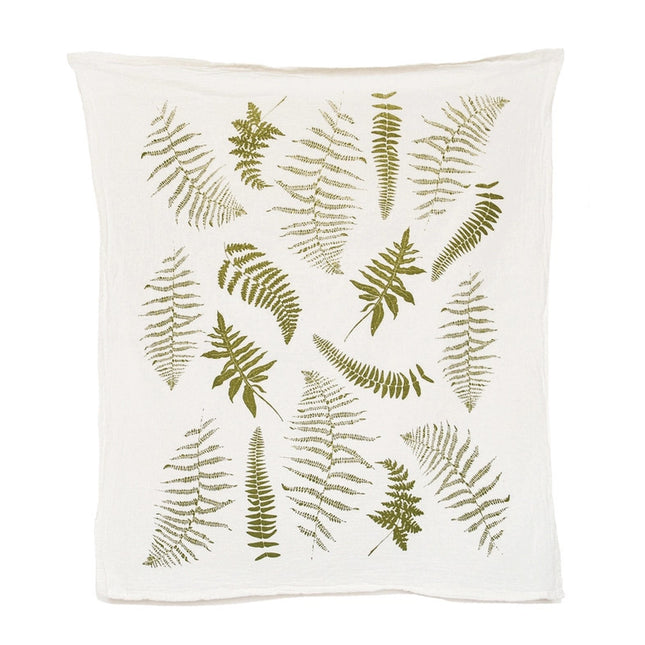 an off white tea towel with illustrations of green fern fronds