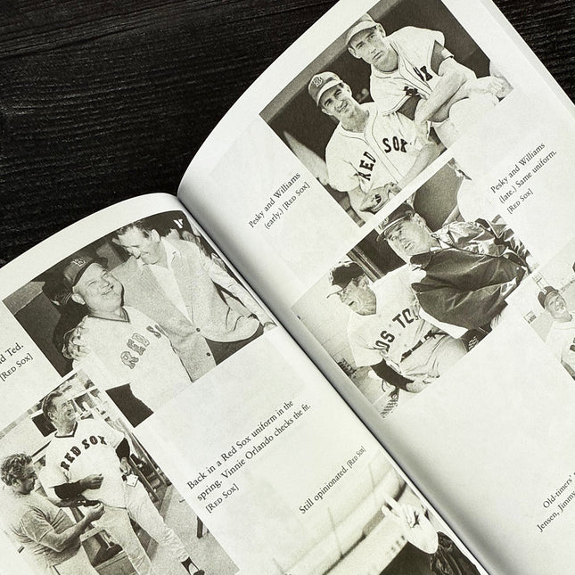 Open book with black and white photographs of baseball players on a wooden surface
