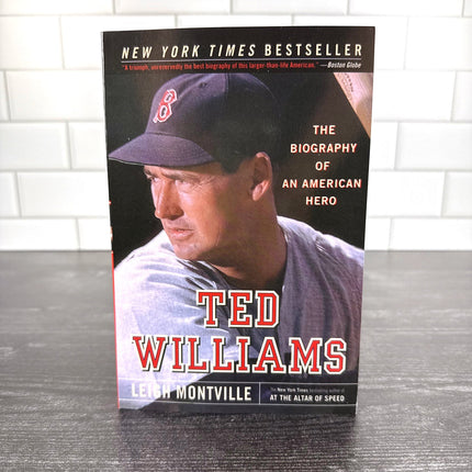 Book titled 'Ted Williams' by Leigh Montville on a wooden surface with a tiled wall background