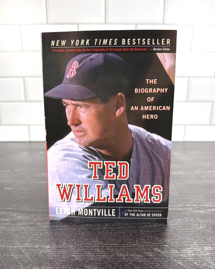 Book titled 'Ted Williams' by Leigh Montville on a wooden surface with a tiled wall background