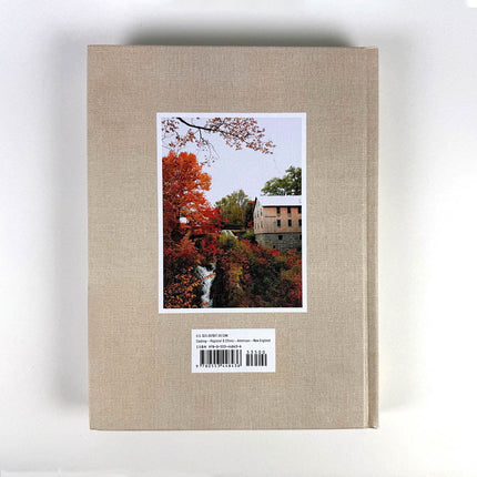Beige book cover with a scenic autumn landscape illustration on a white background
