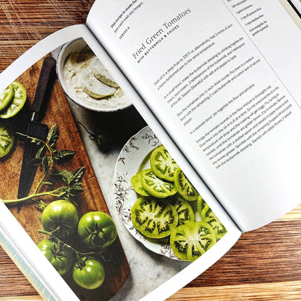 Open cookbook showing images of green tomatoes and a recipe