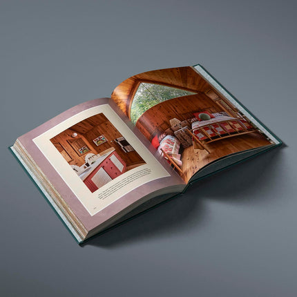 Open book showing interior design images on a gray background