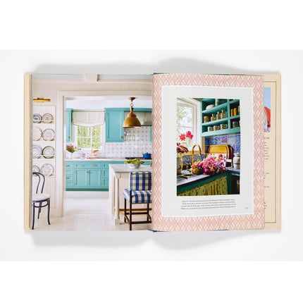 Open book showing images of a kitchen interior with colorful decor.