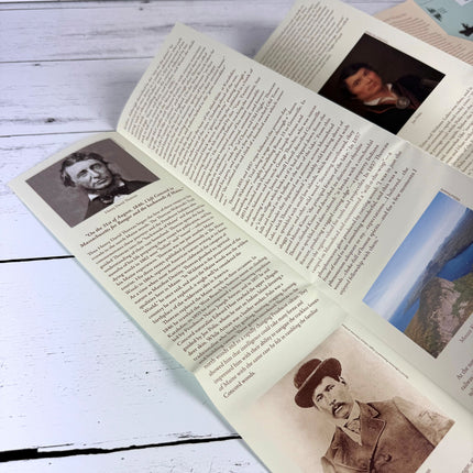 the backside of the Thoreau-Wabanaki map partially unfolded on a white wood table showing the info side with history on Henry David Thoreau