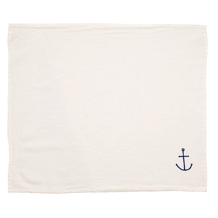 unfolded napkin with a small hand drawn anchor design in blue in the bottom right corner
