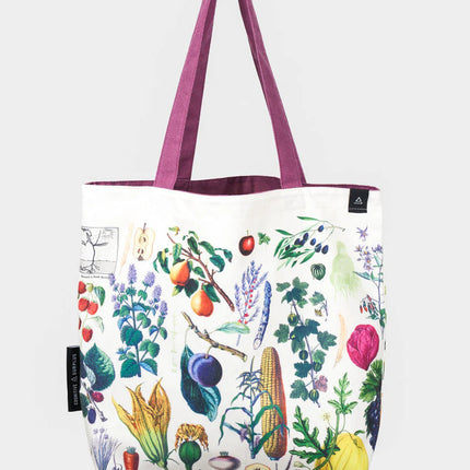 side one of the farmer's market tote; a white tote bag with lavender straps covered in vintage illustrations of fruits and veggies