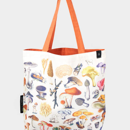 side one of the woodland mushrooms tote; a white tote bag with orange straps covered in vintage illustrations of woodland mushrooms