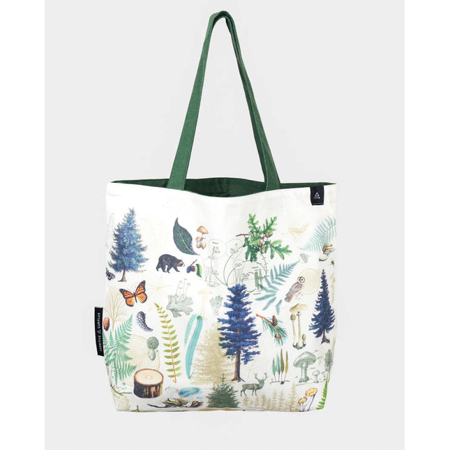 side one of the into the woods tote; a white tote bag with forest green straps covered in vintage illustrations of woodland flora and fauna