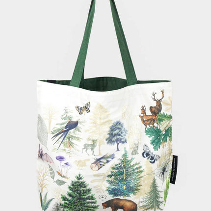 side two of the into the woods tote; a white tote bag with forest green straps covered in vintage illustrations of woodland flora and fauna