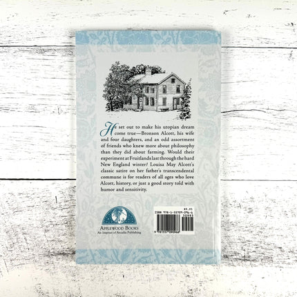 Bookback with text and a house illustration on a wooden surface