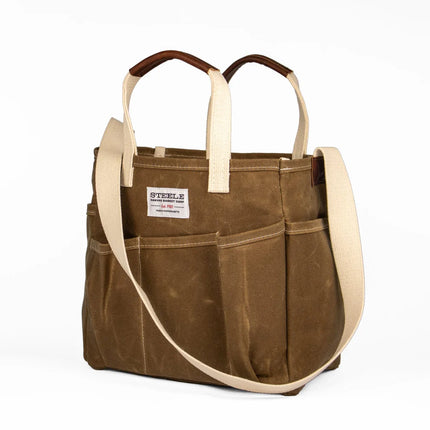 Brown tote bag with beige straps on a white background