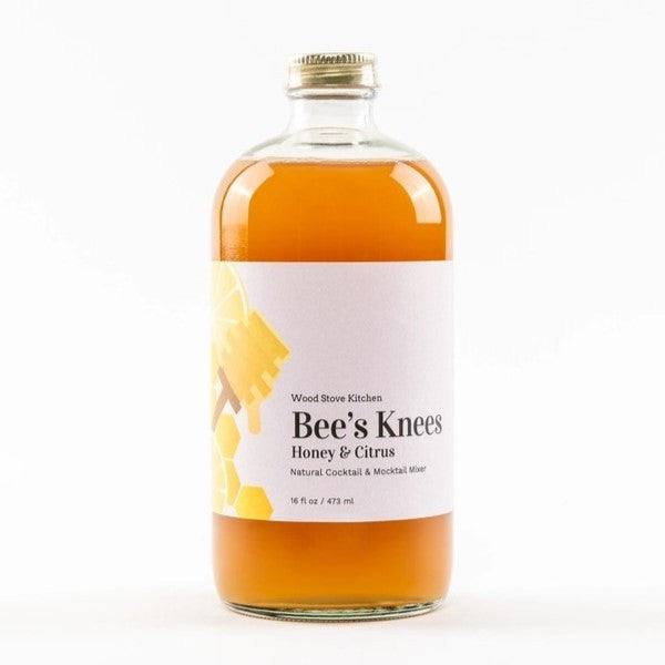 Bee's Knees Mixer bottle featuring a citrus-honey blend for cocktails and beverages. Made in the USA, shelf-stable, with ingredients including honey and lemon juice