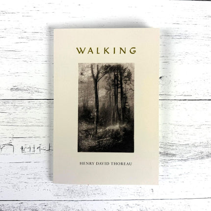 Book cover of 'Walking' by Henry David Thoreau on a wooden surface