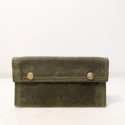 a green waxed canvas fly fishing wallet with brass snap closures