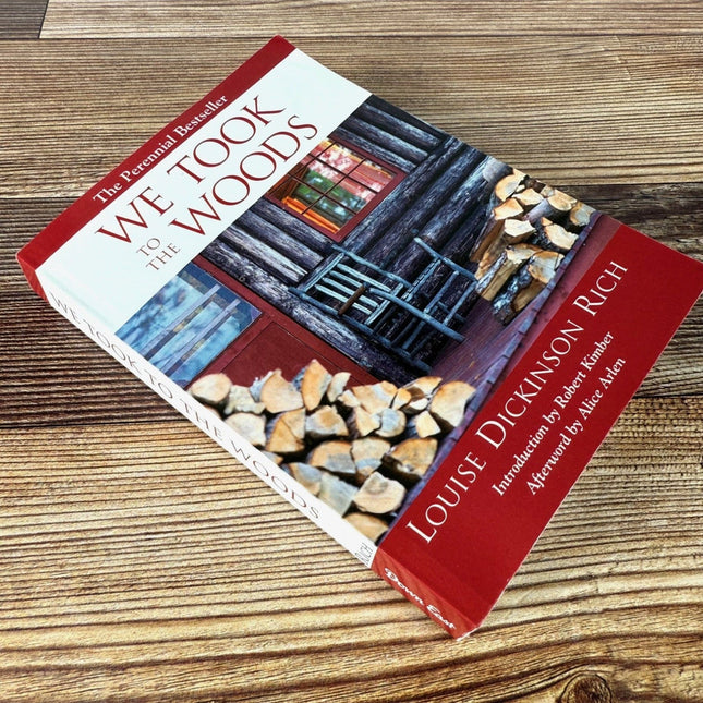 We Took to the Woods book on rustic wood surface shown laying diagonally