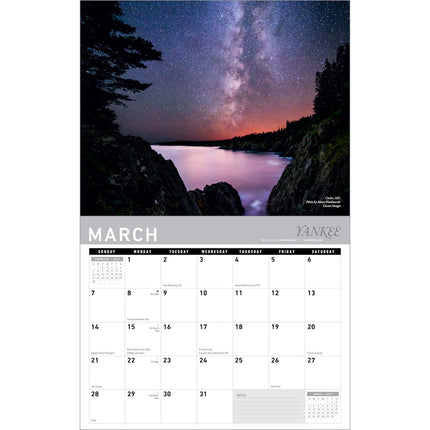 March wall calendar featuring a scenic photograph of the Milky Way over a lake at night, with a white monthly calendar grid below.