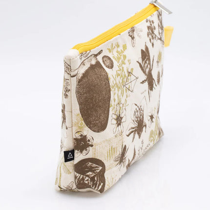 a side angle of white canvas zipper pouch with vintage illustrations of honey bees