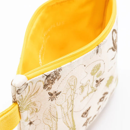 a close up of the honey bee zipper pouch showing the pouch unzipped revealing the solid yellow lining