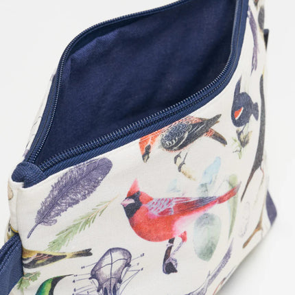 a close up of the birds zipper pouch showing the pouch unzipped revealing the solid navy blue lining