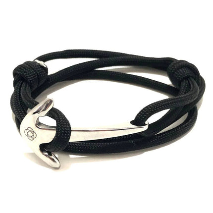 a black cord wrap bracelet that is held in place with a silver anchor charm