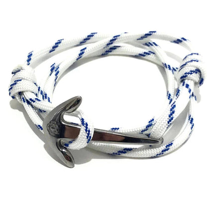 a white with blue stripes wrap bracelet made of cord that is held in place with a silver anchor charm