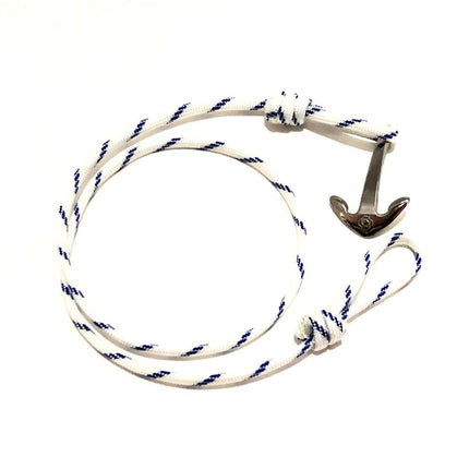 a white with blue stripes wrap bracelet with silver anchor charm unwrapped in a loose circle showing the nearly unwrapped length of the bracelet