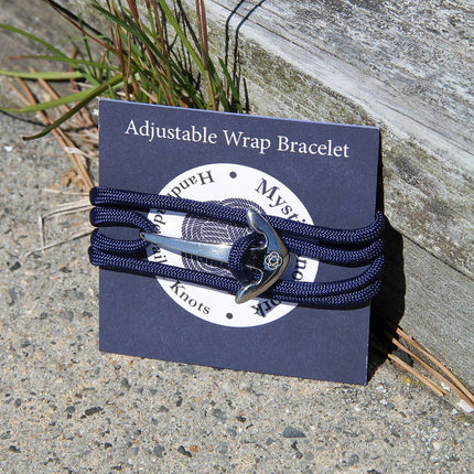 the packaging for the adjustable navy blue wrap bracelet wrapped around a navy blue card that says "Mystic Knotwork"