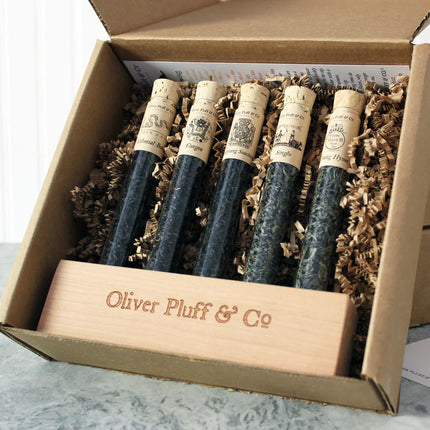 Set of loose tea in test tubes in a branded box with 'Oliver Pluff & Co' on a neutral background