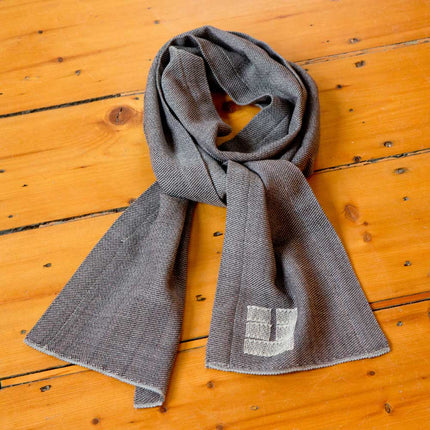the camen scarf in Charcoal on a wooden surface