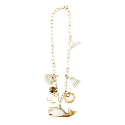 Gold necklace with various charms on a white background