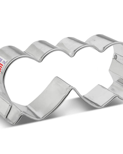 a silver, tin cookie cutter in the shape of folded heart-shaped glasses