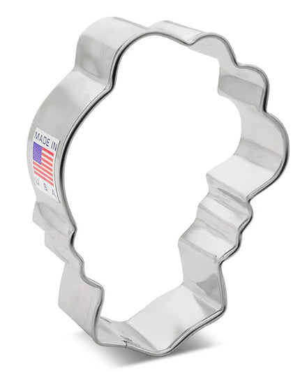 silver tin cookie cutter in the shape of a skull with flowers on top of the head