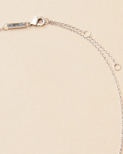 close up of the gold chain that goes with the gibbous slice silver necklace
