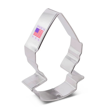 A tin cookie cutter in the shape of an elf's head with a pointed elf hat