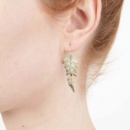 a close up of a model's ear wearing the Fern Earrings