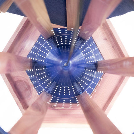a downward view inside the gazebo feeder showing the interior cone that helps direct the bird seed downward to the feeder platform