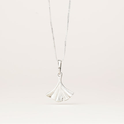 the back of the intricately detailed pewter ginkgo leaf shaped pendant hanging from a silver chain
