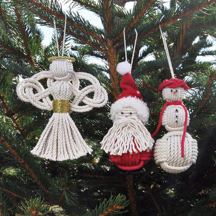 a group of nautical handmade ornaments on an evergreen tree: a nautical angel, a nautical santa, and a nautical snowman