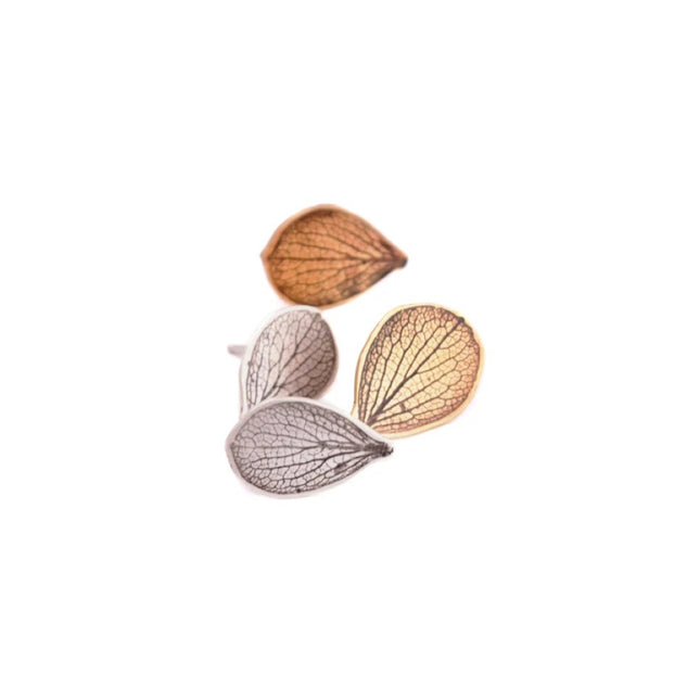 two pairs of hydrangea petal shaped earrings in brass and silver on a white background