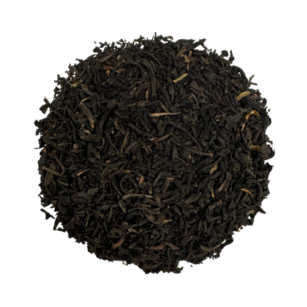 a rounded pile of lapsang souchong tea against a white background