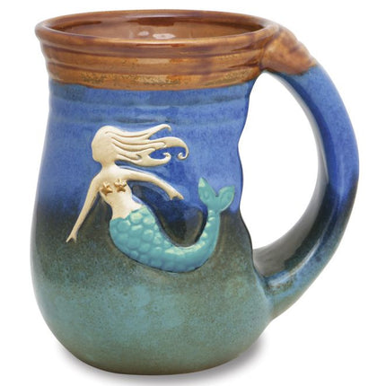 ceramic mug with ombre glaze that ranges from sea green to cobalt blue with a raised mermaid design