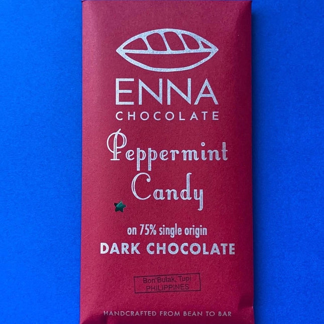A festive burgundy red chocolate bar wrapper with the Enna Chocolate logo and "Peppermint Candy" in playful, festive text