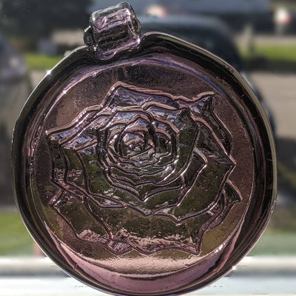 Glass suncatcher with a rose design shown in lighter purple.