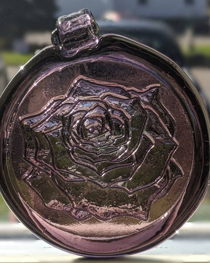 Glass suncatcher with a rose design shown in lighter purple.