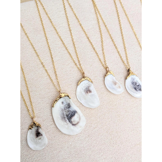 a grouping of 5 Oyster Shell necklaces to show the variation in shell size as well as unique qualities that occur with every shell