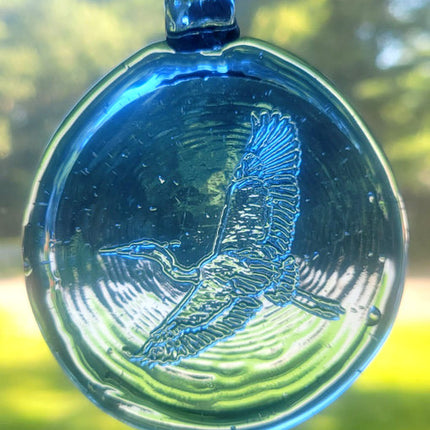 Blue colored glass suncatcher with a heron design.